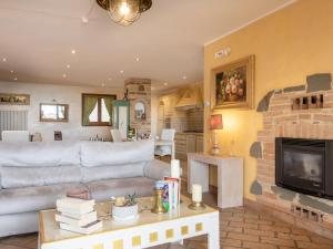 a living room with a couch and a fireplace at Villa Oleandra sul Lago by Interhome in San Feliciano