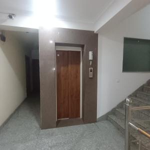 a door in a building with stairs and a screen at Palam residency pg in Gurgaon