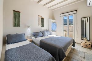 a bedroom with two beds and a window at Kyma in Kardhianí