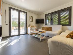 a living room with a couch and a table at Holiday Home La Barca by Interhome in Cambrils