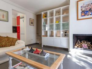 a living room with a fireplace and a couch at Holiday Home La Barca by Interhome in Cambrils +37 photos