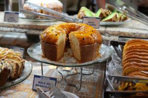 a display of different types of cakes and bread at Foz Presidente Comfort Hotel in Foz do Iguaçu
