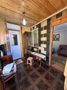 a room with a living room with a table in it at Guest House Iura in Sighnaghi