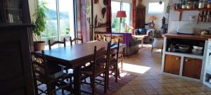 a kitchen and dining room with a table and chairs at Ch'ti Tichenn GR34 in Saint-Michel-en-Grève +12 photos