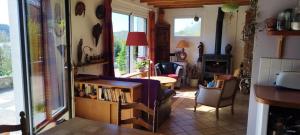 a living room with a table and some chairs at Ch'ti Tichenn GR34 in Saint-Michel-en-Grève