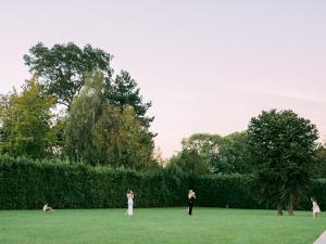 a group of people standing in a grass field at Domaine Les Jardins dArsene in Tinténiac