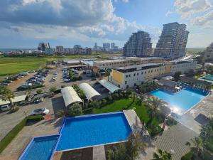 an aerial view of a building with two swimming pools at Caesar Resort Lux Studio Apt in Trikomo
