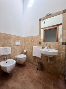 a bathroom with two sinks and a toilet at Agriturismo I Bosconi in Cesena +28 photos