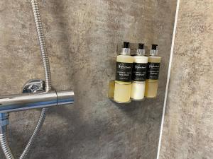 two bottles of essential oils sitting on a bathroom counter at Maggie's Cabin in Oban
