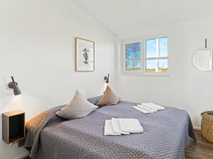 a bedroom with a bed with two towels on it at Holiday Home Haus Schmidt - 305 by Interhome in Lembruch