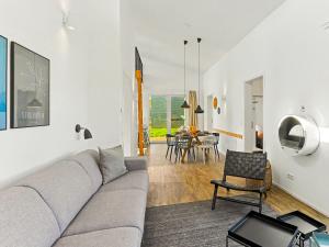 a living room with a couch and a table at Holiday Home Haus Schmidt - 305 by Interhome in Lembruch