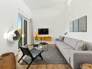 a living room with a couch and a tv at Holiday Home Haus Schmidt - 305 by Interhome in Lembruch +30 photos