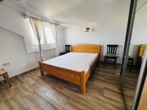 a bedroom with a bed and a chair in it at Bird House in Krimovice