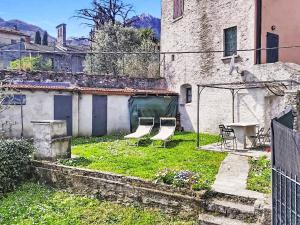 a yard with two chairs and a gazebo at Apartment Lakeview Menaggio by Interhome in Menaggio
