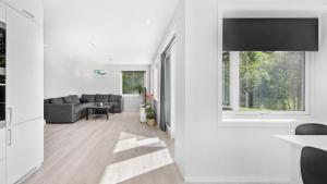 a white living room with a couch and a window at Kvitefjell 35 in Loen