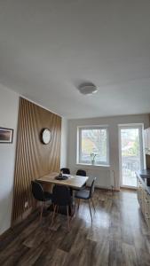 a dining room with a table and chairs at Apartmán Eliašova 2 in Česká Lípa