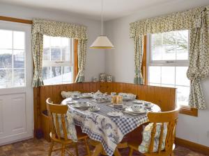 a dining room with a table and chairs and windows at Castle Peroch-Uk5698 in Logierait