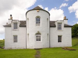 an old white house with a tower on a field at Castle Peroch-Uk5698 in Logierait