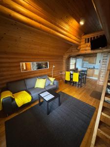 a living room with a couch and a table at Lakeside Cottages in Rastinniemi +41 photos