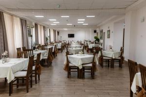 a restaurant with tables and chairs with white tablecloths at Hotel N in Belgrade