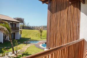 a wooden fence next to a backyard with a swimming pool at Villa Conduru III Kite House Preá 100m from Beach in Cruz