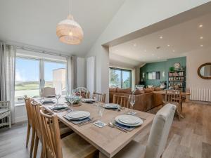 a dining room and living room with a table and chairs at Long Commons in Saint Mawes