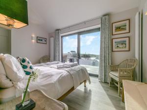 a bedroom with a bed and a large window at Long Commons in Saint Mawes +29 photos