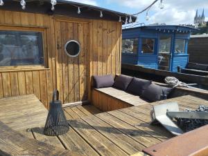 a wooden deck with a couch on a boat at Les Toues Angevines in Angers +4 photos