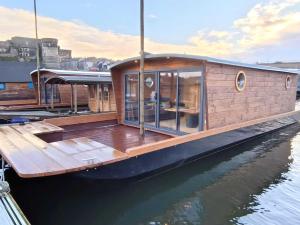 a small wooden boat sitting in the water at Les Toues Angevines in Angers