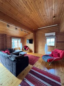 a living room with a couch and a rug at Lakeside Cottages in Rastinniemi