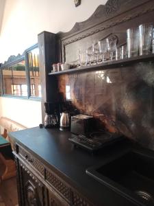 a kitchen with a counter with glasses on a shelf at Murań1 in Bukowina Tatrzańska +24 photos