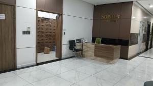 a lobby with a reception desk in a building at SOHA House in Rạch Giá