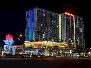 a large building with lights on it at night at SOHA House in Rạch Giá