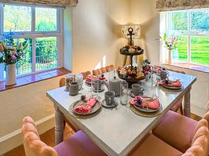 a dining room table with plates of food on it at Falconer's Lodge in Didlington