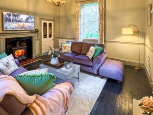 a living room with two couches and a fireplace at Falconer's Lodge in Didlington
