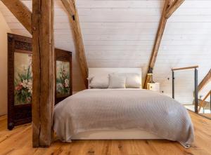 a bedroom with a white bed in a room with wooden floors at Gut Junkernhof in Calden +47 photos