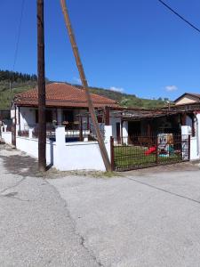 a house with a wooden fence in front of it at Rooster Retreat in Aridaia +38 photos