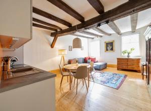 a kitchen and living room with a table and a couch at Gut Junkernhof in Calden