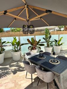 a patio with a blue table and chairs and plants at Dimora del tramonto in Trani
