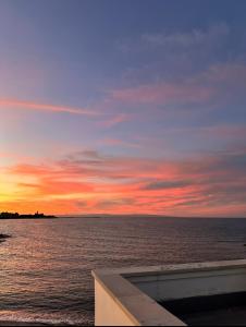 a sunset over a body of water with the ocean at Dimora del tramonto in Trani +3 photos