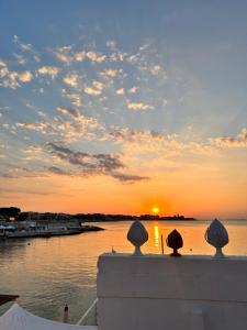 a sunset over a body of water with boats at Dimora del tramonto in Trani