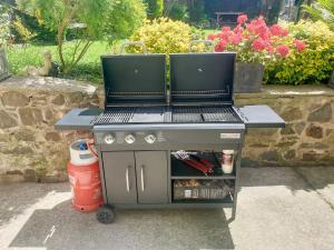 a bbq grill with a table on top of it at Awel-Y-Mor in Aberaeron
