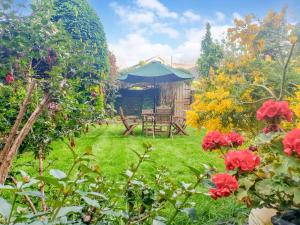 a garden with a table and chairs and flowers at Awel-Y-Mor in Aberaeron