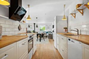 a kitchen with a sink and a refrigerator at 30459-Odder-Solskraenten-2 in Odder +24 photos