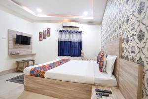 a bedroom with a bed and a television in it at FabHotel Garden Tree in Bhubaneshwar +38 photos