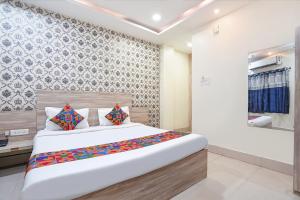 a bedroom with a large bed in a room at FabHotel Garden Tree in Bhubaneshwar