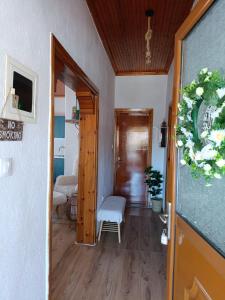a hallway with a door open to a living room at Rooster Retreat in Aridaia