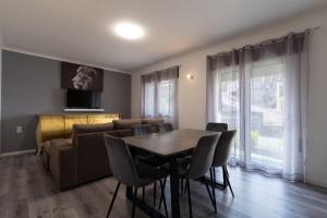 a living room with a table and a couch at Gerês Home Nature in Geres