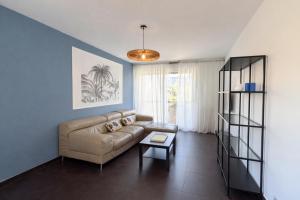 a living room with a couch and a table at M031 Joli t3 centre d'Annemasse in Annemasse