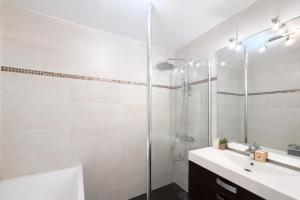 a white bathroom with a shower and a sink at M031 Joli t3 centre d'Annemasse in Annemasse
